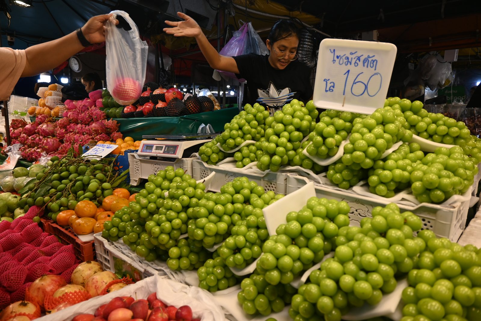 DFC 2099 A bustling market stall piled high with bright gree